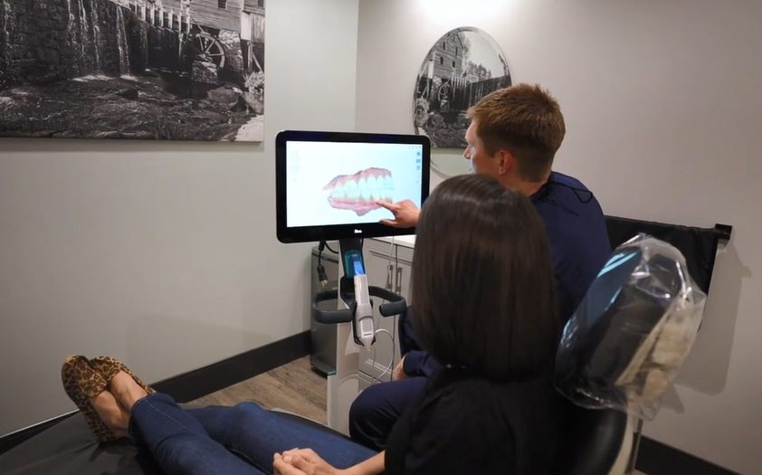 Dentist reviewing an X-ray with a patient in Cary, NC
